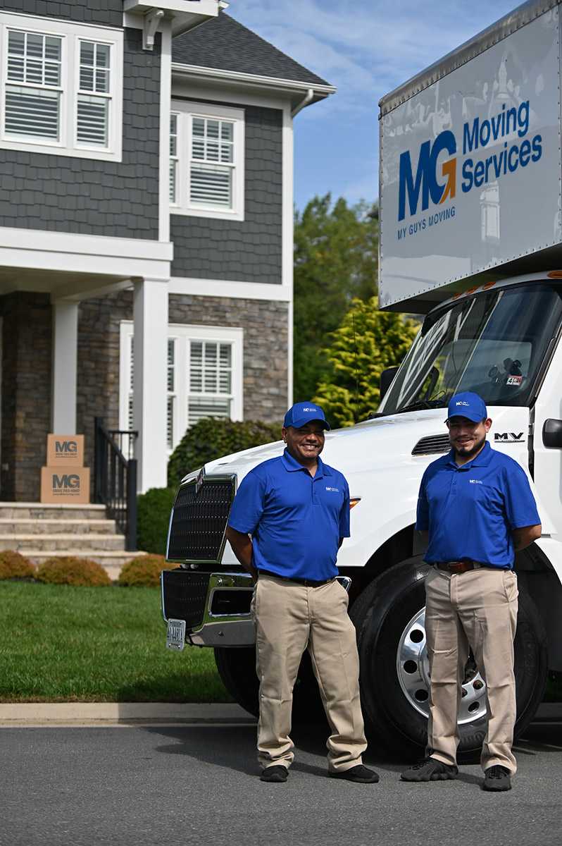 mg movers by truck in front of house