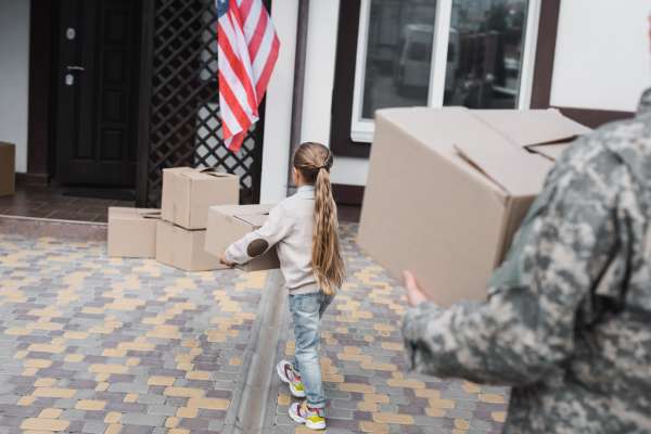 Father in military with his daughter moving