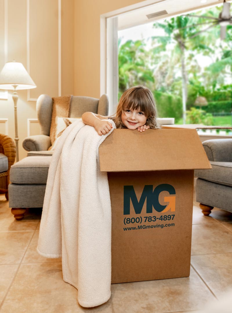 girl hiding in a moving box