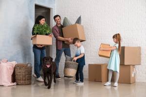 Family with cardboard boxes after moving into new house