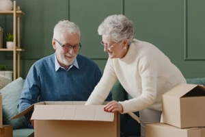 senior couple unpacking boxes after a move