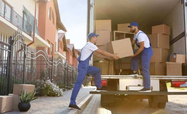 workers unloading boxes from van outdoors