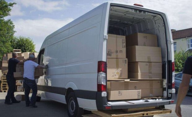 truck movers loading van carrying boxes