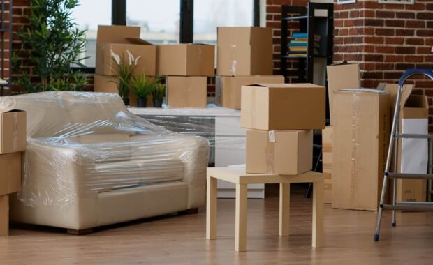 household space with cardboard boxes used for relocation, moving home furniture in carton containers and storage equipment