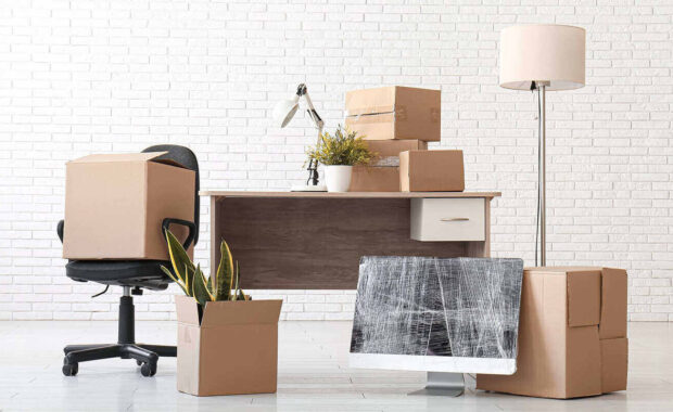 wrapped computer monitor and chair in office on moving day