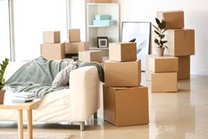 furniture, belongings and moving boxes in room